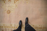 View of the varied pile height and abrashed mauve-lavender ground of an antique Agra carpet.