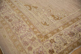 Antique Agra carpet corner showing varied pile texture in mauve, pale bronze, and ivory tones.