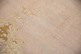 Detail of the time-softened wool pile and abrashed mauve ground on an antique Agra carpet.