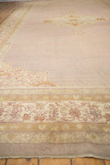 Detailed ivory floral border and open mauve field of a late 19th century Agra carpet.