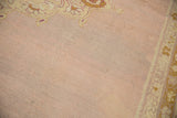 Low pile texture and color abrasion on the mauve field of an antique Agra carpet.