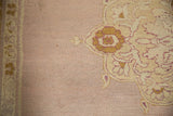 Detail of the abrashed mauve field and varied pile texture of an antique Agra carpet.