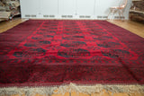 Lustrous cherry red Vintage Ersari carpet featuring navy teal elephant gul motifs.