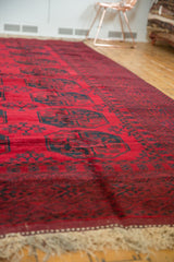 Thick cherry red pile with dark dusty navy teal elephant footprint gul motifs.