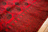 Thick cherry red pile with elephant footprint gul motif and original side selvage.