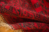 Vintage Ersari carpet's thick cherry red pile, dark teal gul patterns, and braided selvage.