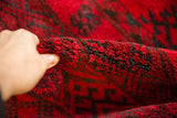 Thick, full cherry red pile displaying dark navy gul patterns on the Ersari rug.