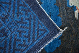 Close-up of hand-knotted selvage, indigo geometric border, cobalt blue on charcoal.