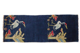 Antique Peking pillar rug runner with pictorial birds and botanicals on a saturated cobalt blue field.