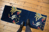 Hand-knotted Peking rug runner in cobalt blue with bird motifs, shown from above for scale.