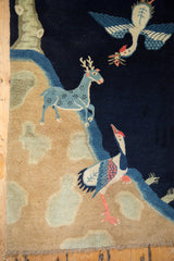 Flying bird with offering and blue deer motif on vintage Chinese Peking pictorial rug.