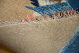 Hand-knotted beige foundation, natural fringe, and blue pictorial pile of a vintage Peking rug.