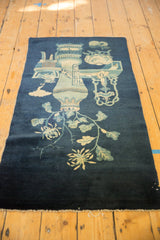 Secure light fringe with deep indigo blue field and pale floral motifs on antique Peking rug.