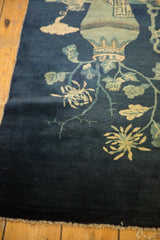 Antique Peking rug's lower corner, showing secured fringe and celadon floral motifs.