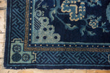 Antique Peking rug corner, indigo blue geometric borders, and powder blue lightning spandrel motif.