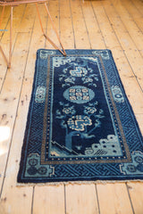 Indigo blue geometric lightning corner spandrel and natural fringe on an antique Peking rug.
