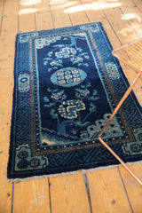 Antique Chinese Peking rug corner detail: indigo field, lightning spandrel, geometric borders.