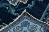 Antique Peking rug corner with indigo pile, powder blue geometric border, and intact selvages.