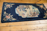 A perspective view of the antique Peking runner, showing its pictorial design and balanced composition.
