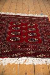 Crisp white fringe and intricate geometric borders of a vintage Bokhara rug.