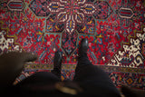 Vintage Heriz carpet's classic geometric pattern, showcasing cherry red, navy blue, and ivory floral motifs.