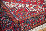 Plush, full pile on the corner of a vintage Mehrivan carpet, showing its geometric borders and ivory fringe.