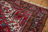 Plush full pile and geometric borders in red, navy, and bronze on a vintage Mehrivan carpet.