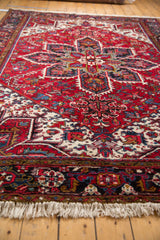 Low perspective view of a vintage Mehrivan carpet's dense pile and geometric Heriz-style design.