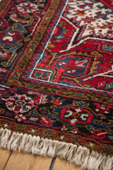 Intricate geometric border and plush, full pile on the corner of a vintage Mehrivan carpet.