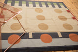Contemporary kilim rug featuring bold orange, camel circles and charcoal stripes.