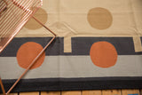 Abstract contemporary kilim pattern with terracotta rust circle and dark stripes.
