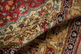Full, soft pile of a vintage rug showing detailed floral arabesques in red, ivory, and blue.