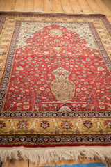 Angled view of a vintage Romanian rug showing the full pile and unidirectional tree of life design.