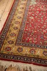 Intricate floral arabesque border and plush cherry red pile of a vintage Romanian Hereke rug.