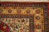 Corner of a vintage Hereke design rug showing the blossomed floral arabesque borders and original ivory fringe.