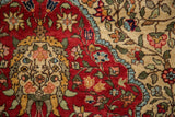 Close-up of the blossomed floral arabesques in cherry red, ivory, and powder blue.