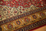 Blossomed floral arabesques in the cherry red, ivory, and blue border of a vintage Hereke rug.