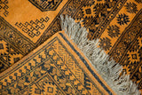 Original wool fringe and intact selvage on a hand-knotted saffron yellow Daulatabad rug.