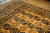 Vintage Daulatabad carpet corner with saffron yellow pile and intricate dark navy geometric borders.