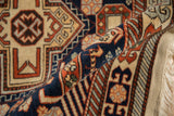 Intricate geometric patterns in rust and navy on the plush pile of a rolled vintage Romanian rug.