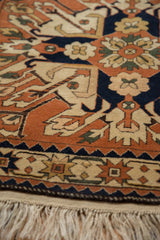 Vintage Romanian Kazak rug corner showing its full wool pile, geometric borders, and tidy fringe.