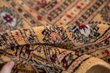 Close-up on the soft, dense texture of the vintage Bokhara rug's full wool pile.