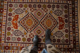 Full pile texture of a vintage Romanian rug with rust and gold stepped diamond medallions.
