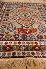 Low angle shot showing the dense pile and intricate geometric motifs of a vintage Romanian rug.