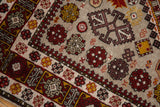 Detailed view of the full pile on a vintage Romanian rug with rust and gold geometric motifs.