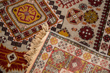 Full pile and intact fringe on the corner of a vintage Romanian rug with geometric designs.