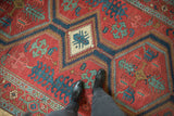 Central diamond medallion and expressive leaf motifs of a late 19th-century Persian Serapi runner.