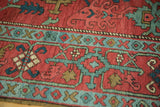 Close view of the even, hand-knotted pile and geometric patterns of an antique Serapi rug runner.