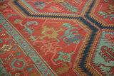 Expressive large-scale leaf motifs in blue and green on the brick-red field of an antique Serapi runner.