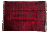 Vintage Afghani Ersari carpet with triple columns of charcoal Bokhara guls on a deep cherry red field.